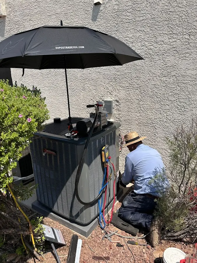 HVAC technician performing outdoor AC maintenance in South Sioux City