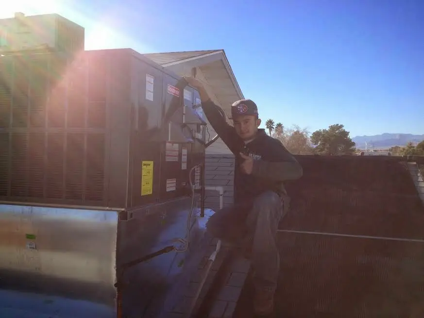 HVAC technician performing Boiler Repair on a rooftop unit in South Sioux City